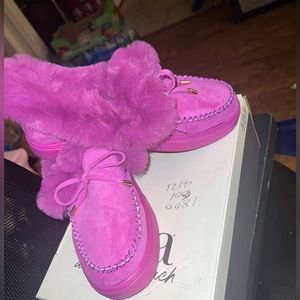 Purple slip on moccasin like shoes.
